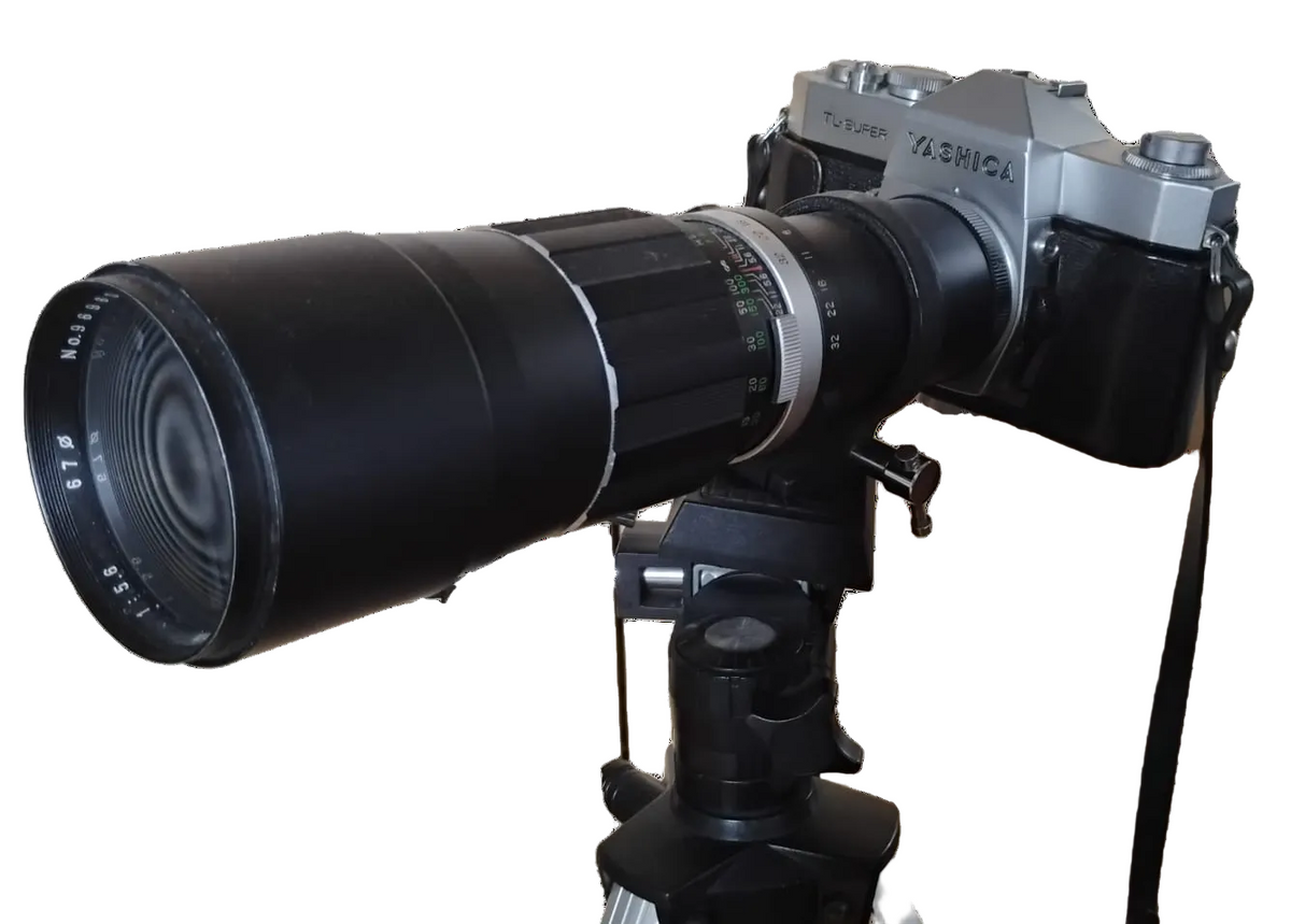 Vintage camera with a large lens on a white background
