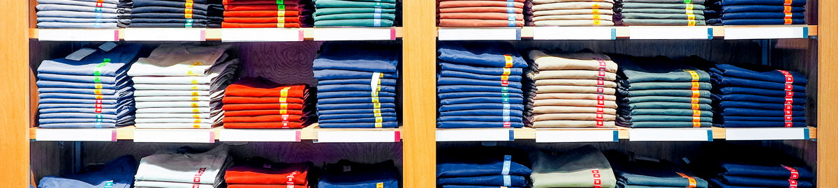 Shelves with folded clothes in a store setting